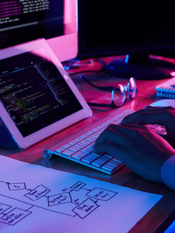 Close-up image of programmer working at his desk in office