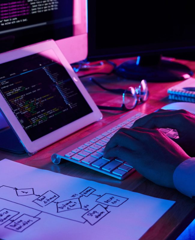 Close-up image of programmer working at his desk in office